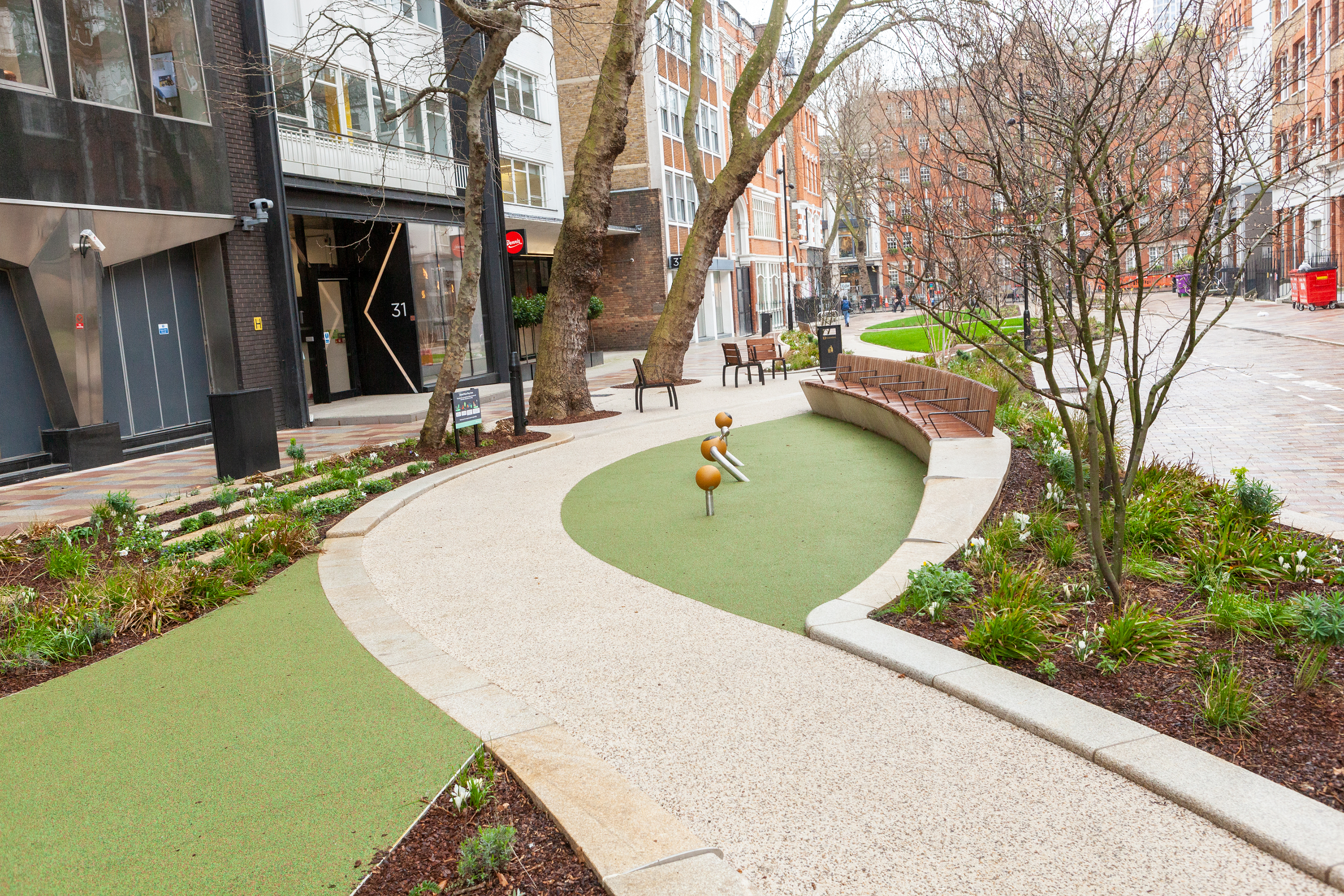 After - Play equipment, sweeping paths and beautiful new plants