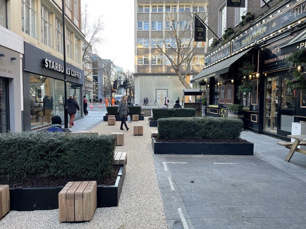 Planters and seating replace what was once a road