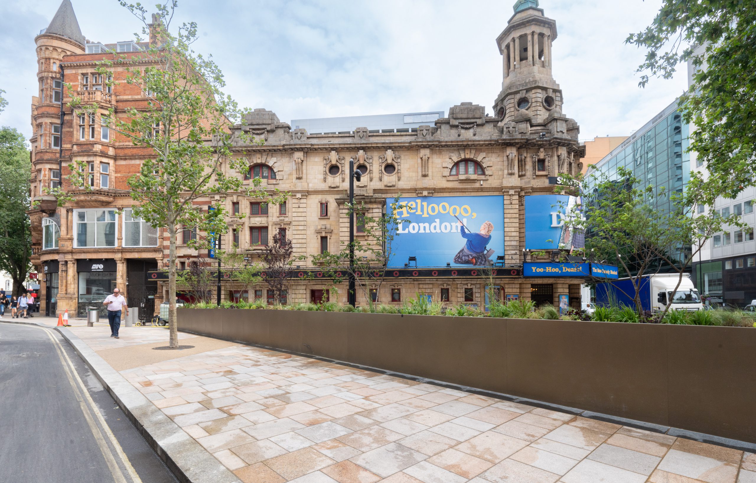 View of the Shaftesbury theatre with new planting, wide pavements and public space